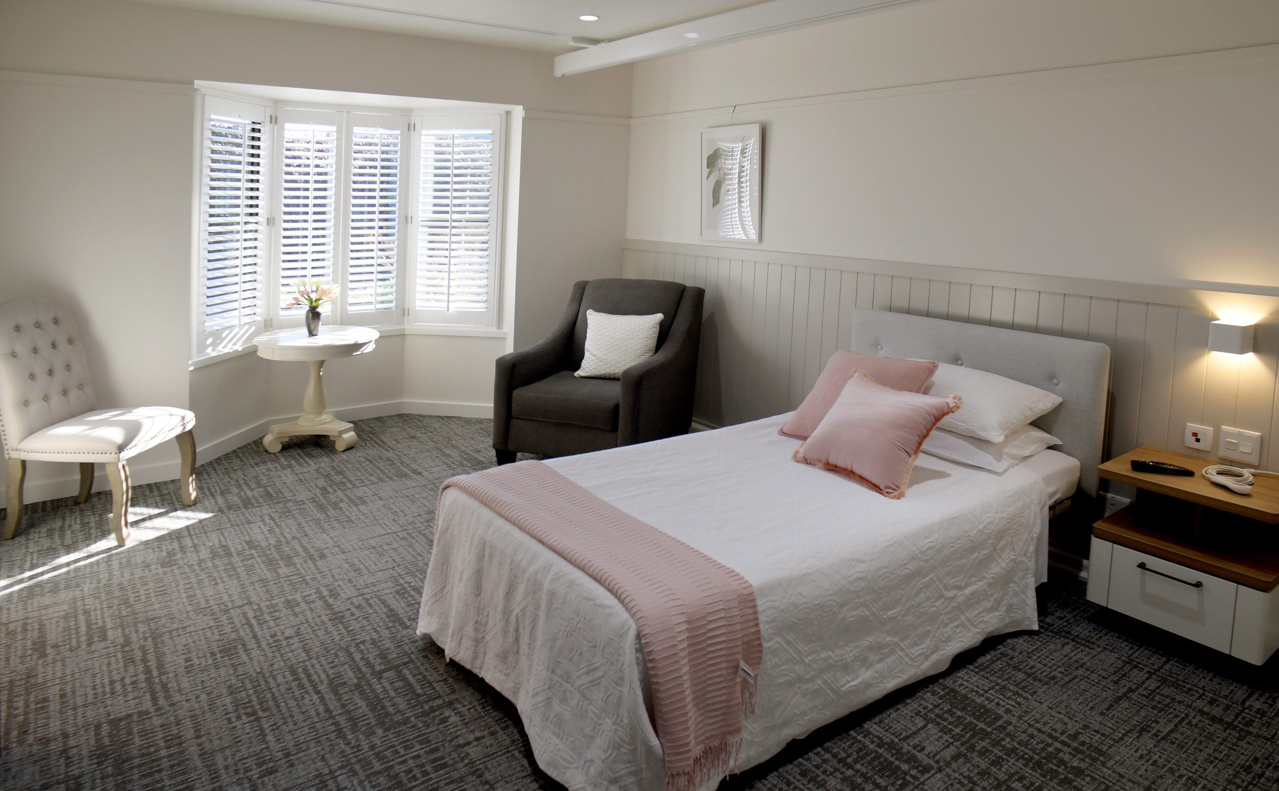 St Catherine's room with a neatly made bed and a comfortable sofa, creating a cosy and welcoming space